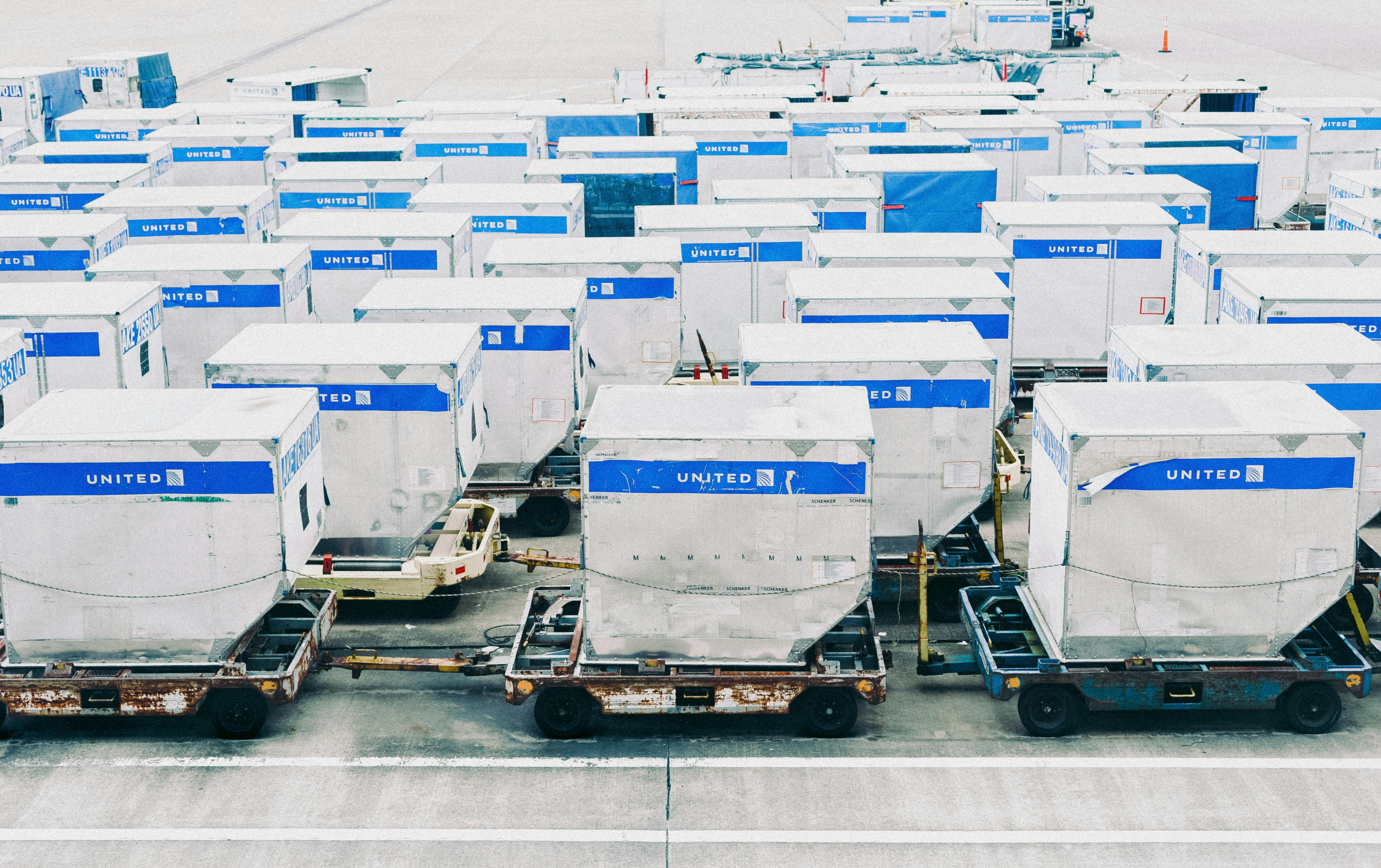 Rows of airline cargo containers prepared for air freight operations